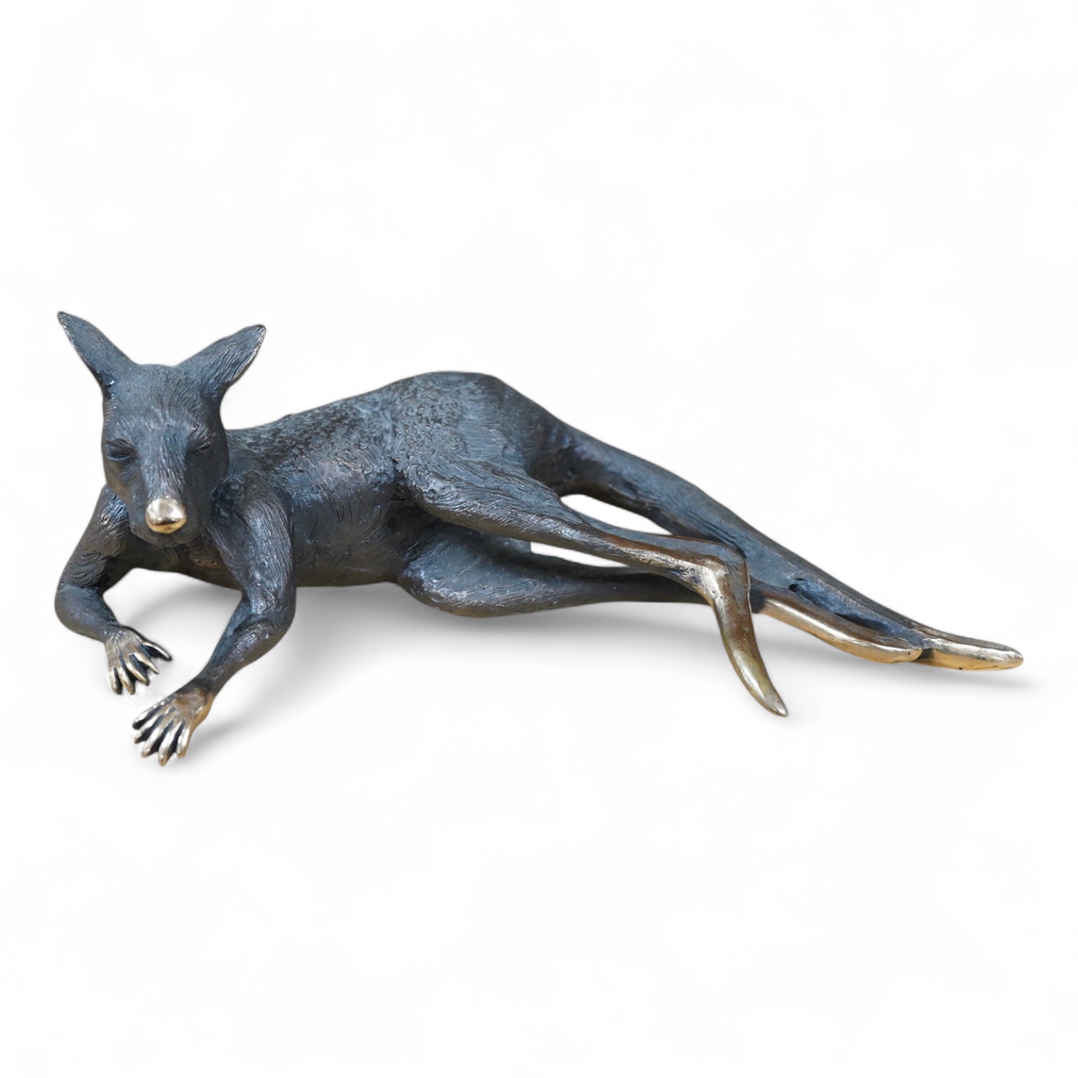 A late 20th century Australian partially gilt bronze model of a recumbent kangaroo, limited edition 5/50, 26cm wide